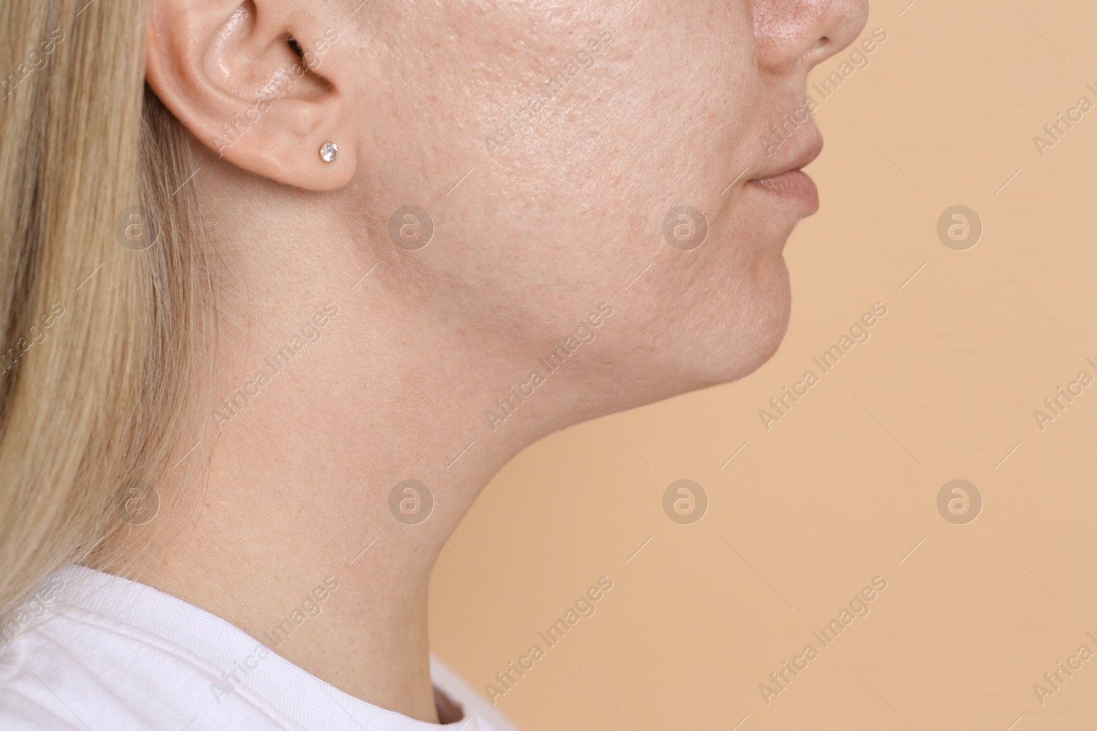 Closeup view of woman on beige background, space for text Photo of Closeup view of woman on beige background, space for text