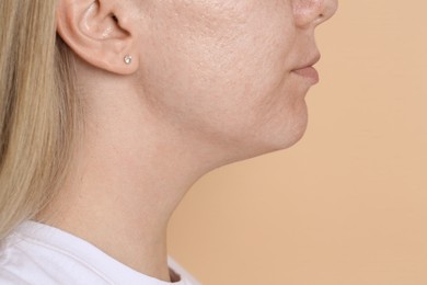 Photo of Closeup view of woman on beige background, space for text