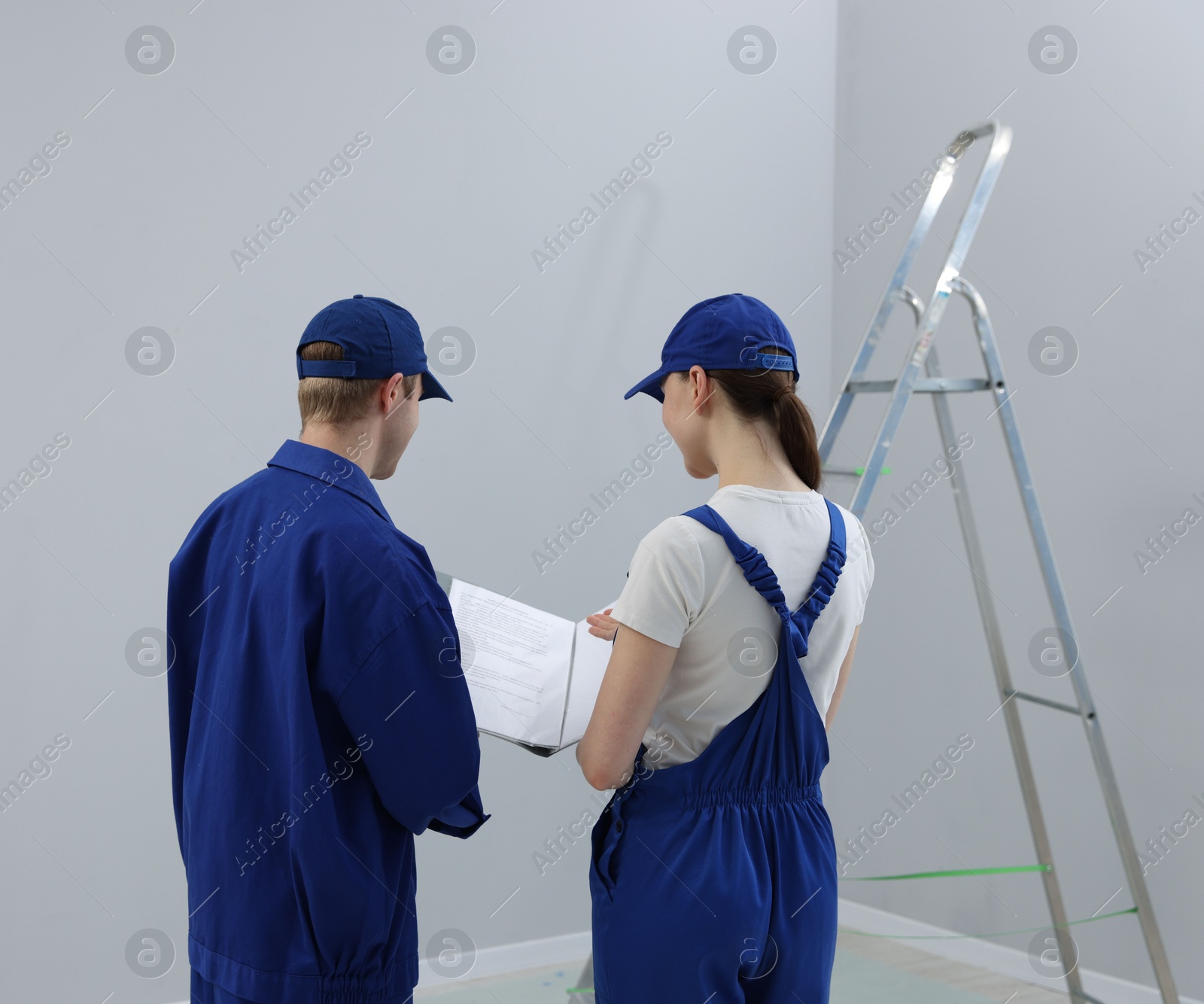 Workers looking at design project in room, back view Photo of Workers looking at design project in room, back view