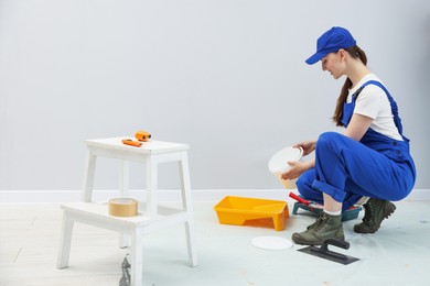Photo of Workers with different equipment doing renovation in room