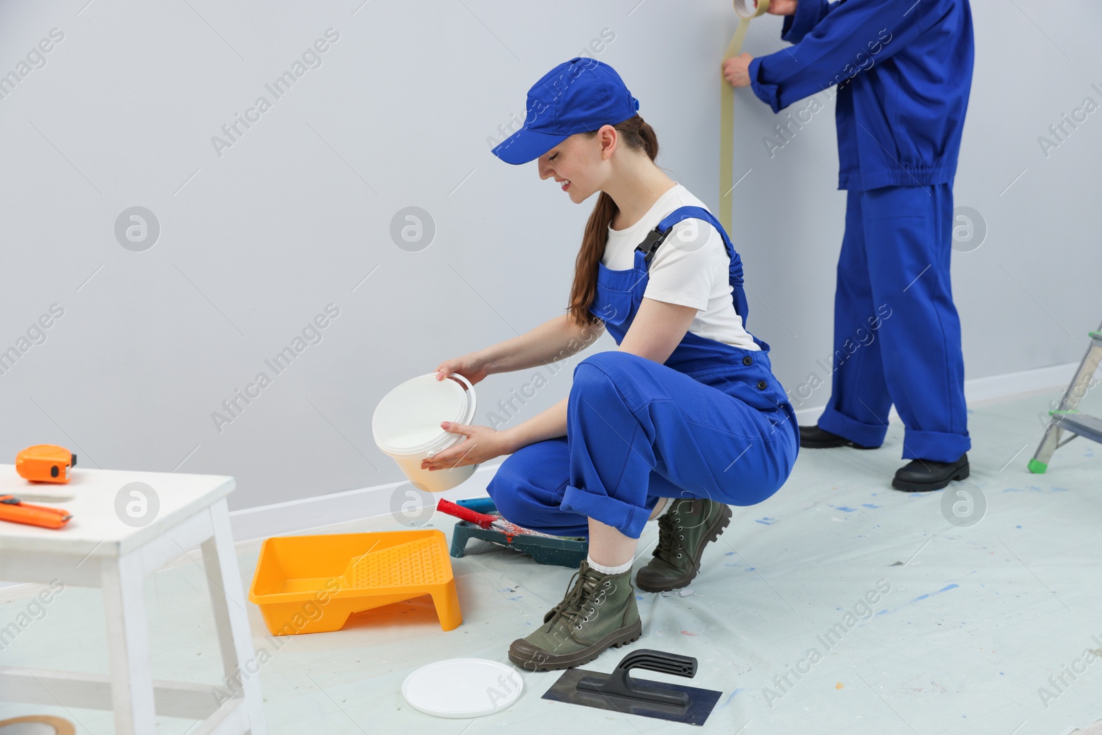 Workers with different equipment doing renovation in room Photo of Workers with different equipment doing renovation in room