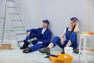 Photo of Workers having break during renovation in room