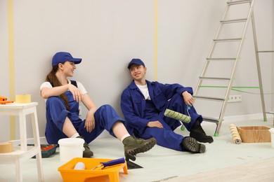 Photo of Workers having break during renovation in room
