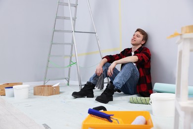 Photo of Man having break during renovation in room