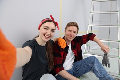 Photo of Couple taking selfie during renovation in room