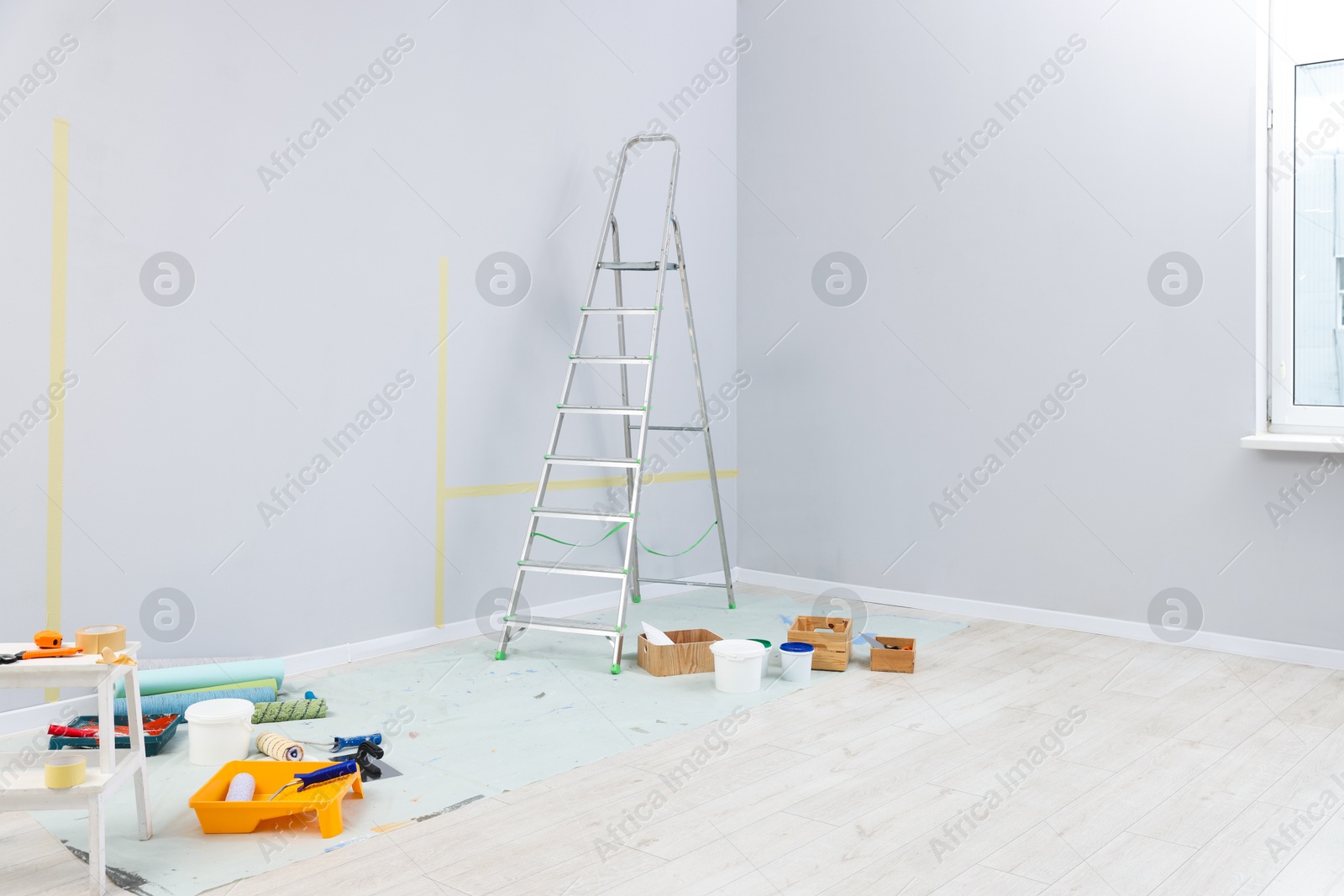 Ladder, paints and other equipment in room Photo of Ladder, paints and other equipment in room