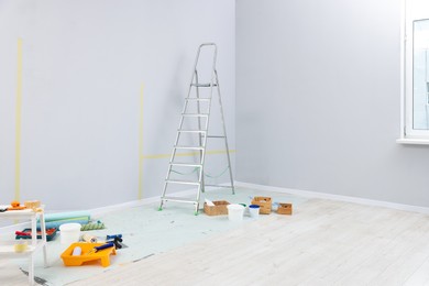 Photo of Ladder, paints and other equipment in room