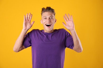 Photo of Portrait of surprised man on orange background