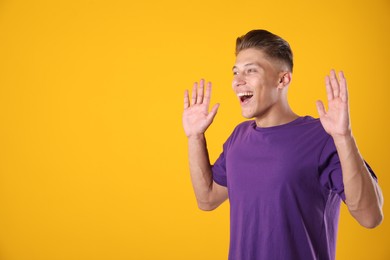 Photo of Portrait of surprised man on orange background, space for text