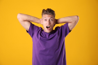 Photo of Portrait of surprised man on orange background