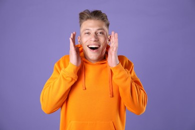 Photo of Portrait of surprised man on purple background