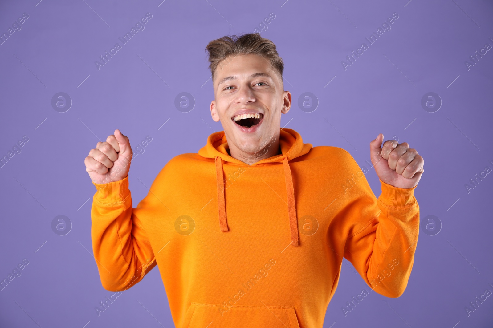 Portrait of surprised man on purple background Photo of Portrait of surprised man on purple background
