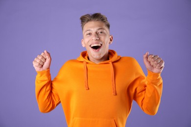 Photo of Portrait of surprised man on purple background