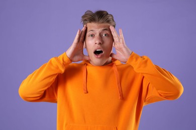 Photo of Portrait of surprised man on purple background