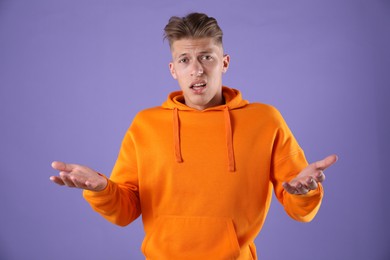 Photo of Portrait of surprised man on purple background