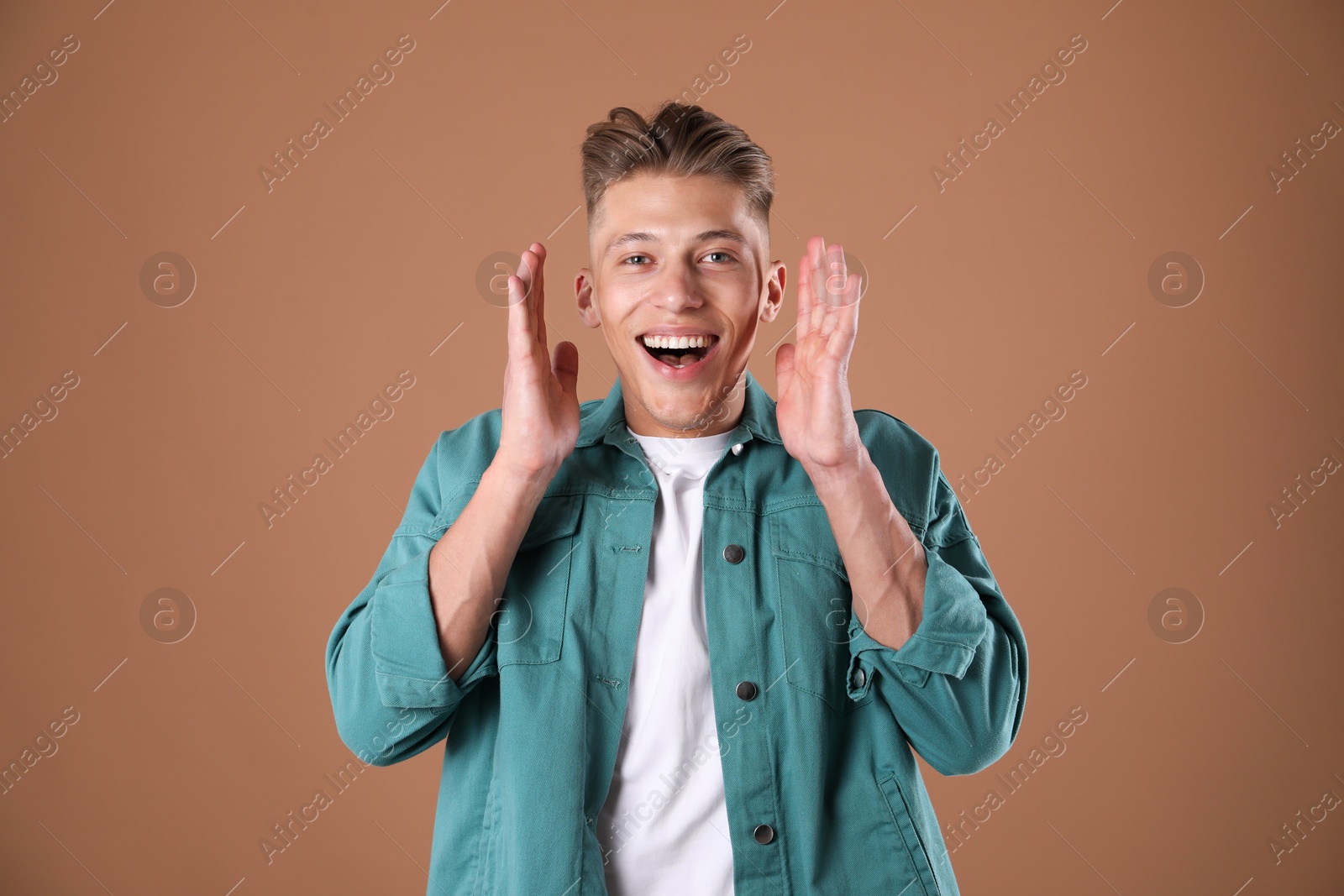 Portrait of surprised man on brown background Photo of Portrait of surprised man on brown background