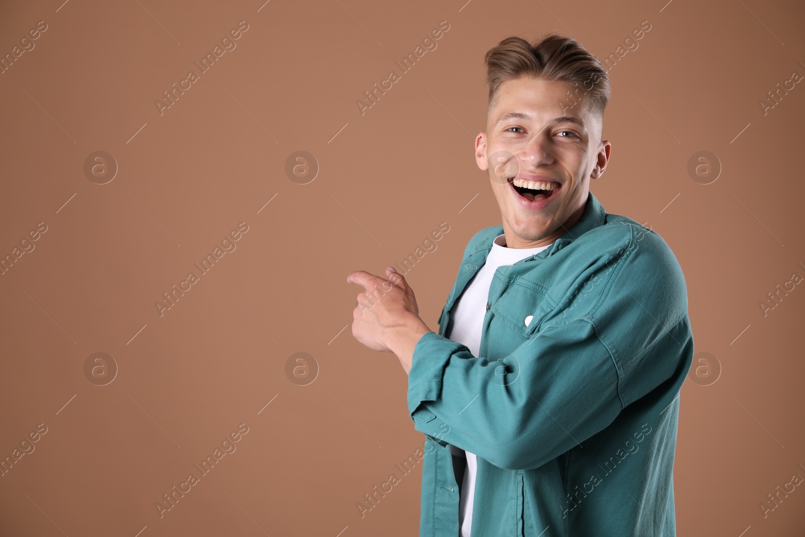 Portrait of surprised man on brown background, space for text Photo of Portrait of surprised man on brown background, space for text