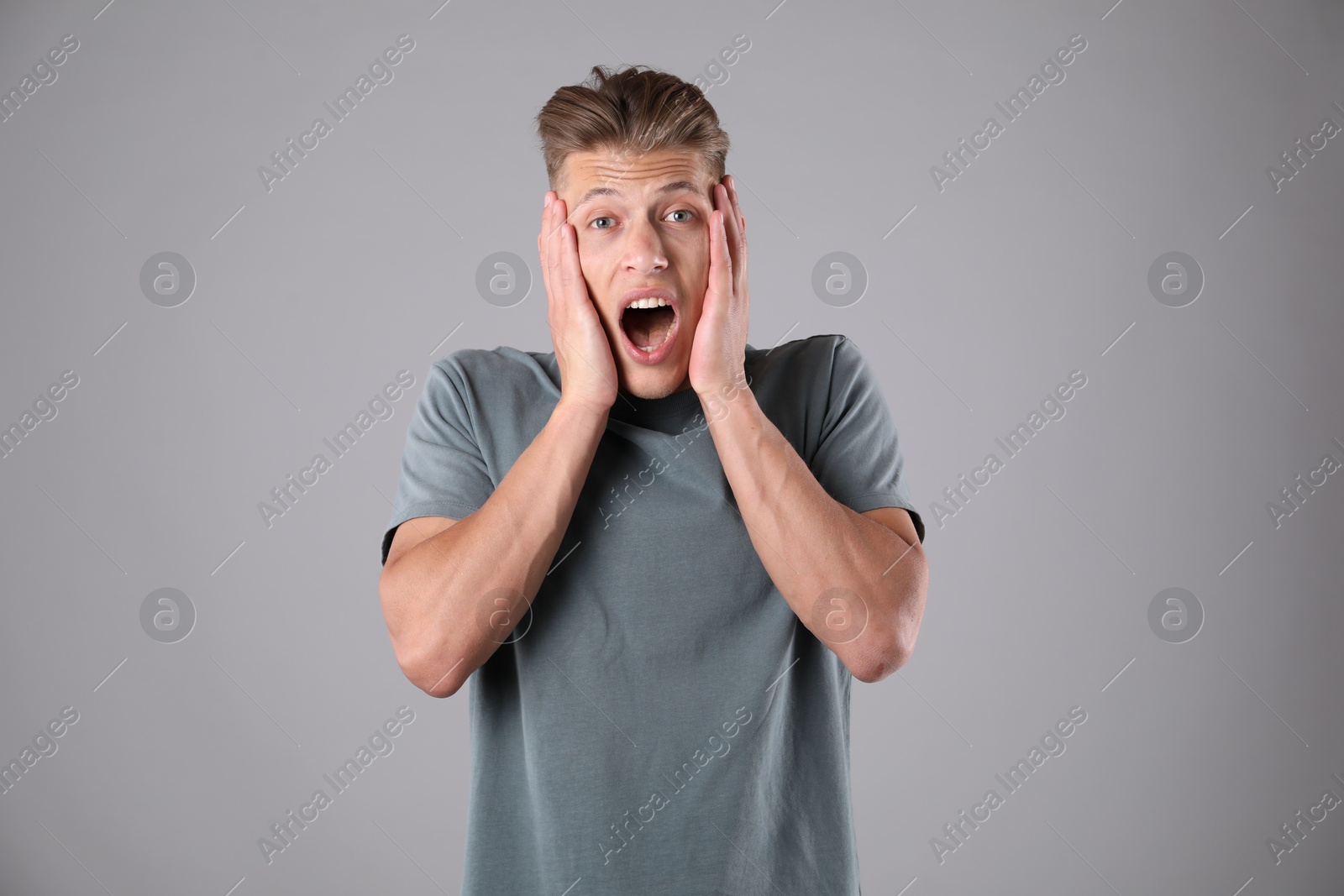 Portrait of surprised man on grey background Photo of Portrait of surprised man on grey background