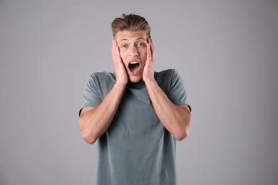 Photo of Portrait of surprised man on grey background