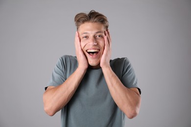 Photo of Portrait of surprised man on grey background