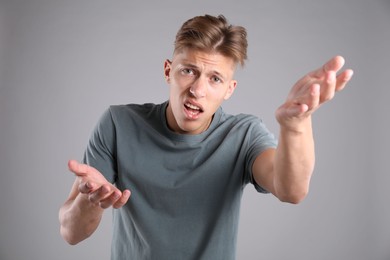 Photo of Portrait of confused man on grey background