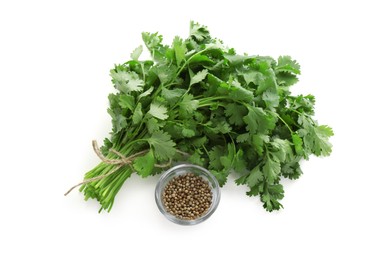 Photo of Fresh cilantro and coriander seeds isolated on white, top view