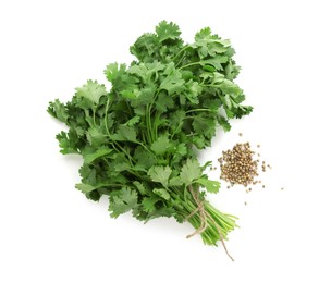 Photo of Fresh cilantro and coriander seeds isolated on white, top view
