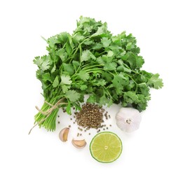 Photo of Fresh cilantro, coriander seeds, lime and garlic isolated on white, top view