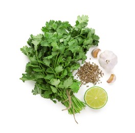Photo of Fresh cilantro, coriander seeds, lime and garlic isolated on white, top view