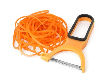 Photo of Raw carrot noodles and peeler isolated on white. Vegetarian dish