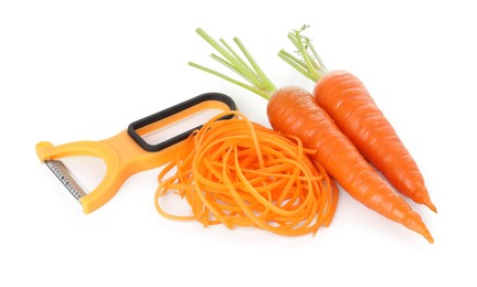 Photo of Raw carrot noodles, peeler and fresh vegetables isolated on white. Vegetarian dish