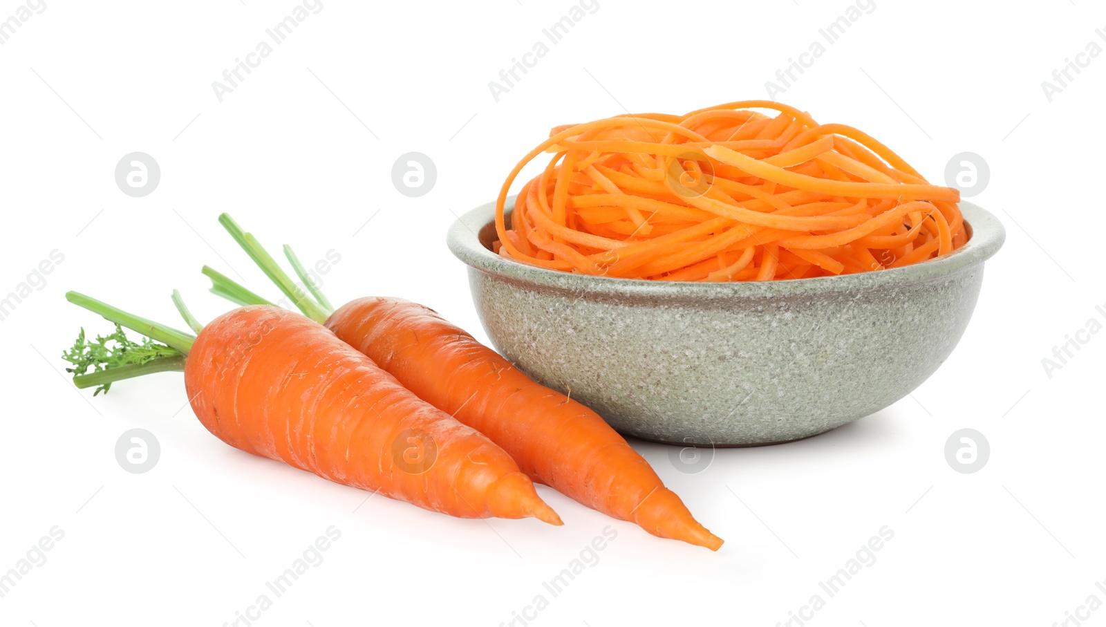 Raw carrot noodles and fresh vegetables isolated on white. Vegetarian dish Photo of Raw carrot noodles and fresh vegetables isolated on white. Vegetarian dish