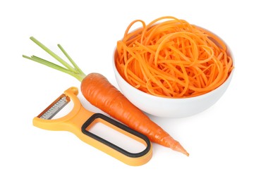 Photo of Raw carrot noodles, peeler and fresh vegetable isolated on white. Vegetarian dish
