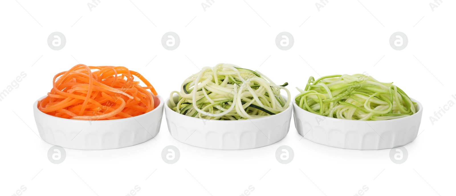 Photo of Different vegetable noodles in bowls isolated on white. Vegetarian dish