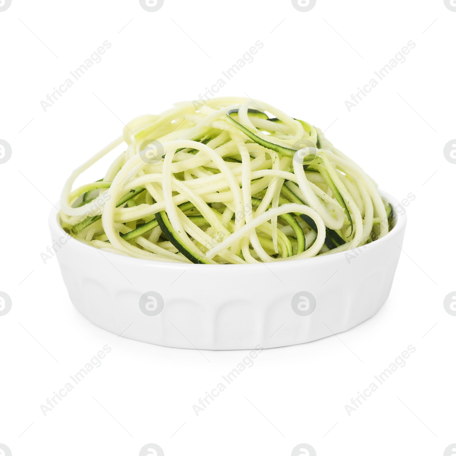 Raw zucchini noodles in bowl isolated on white. Vegetarian dish Photo of Raw zucchini noodles in bowl isolated on white. Vegetarian dish