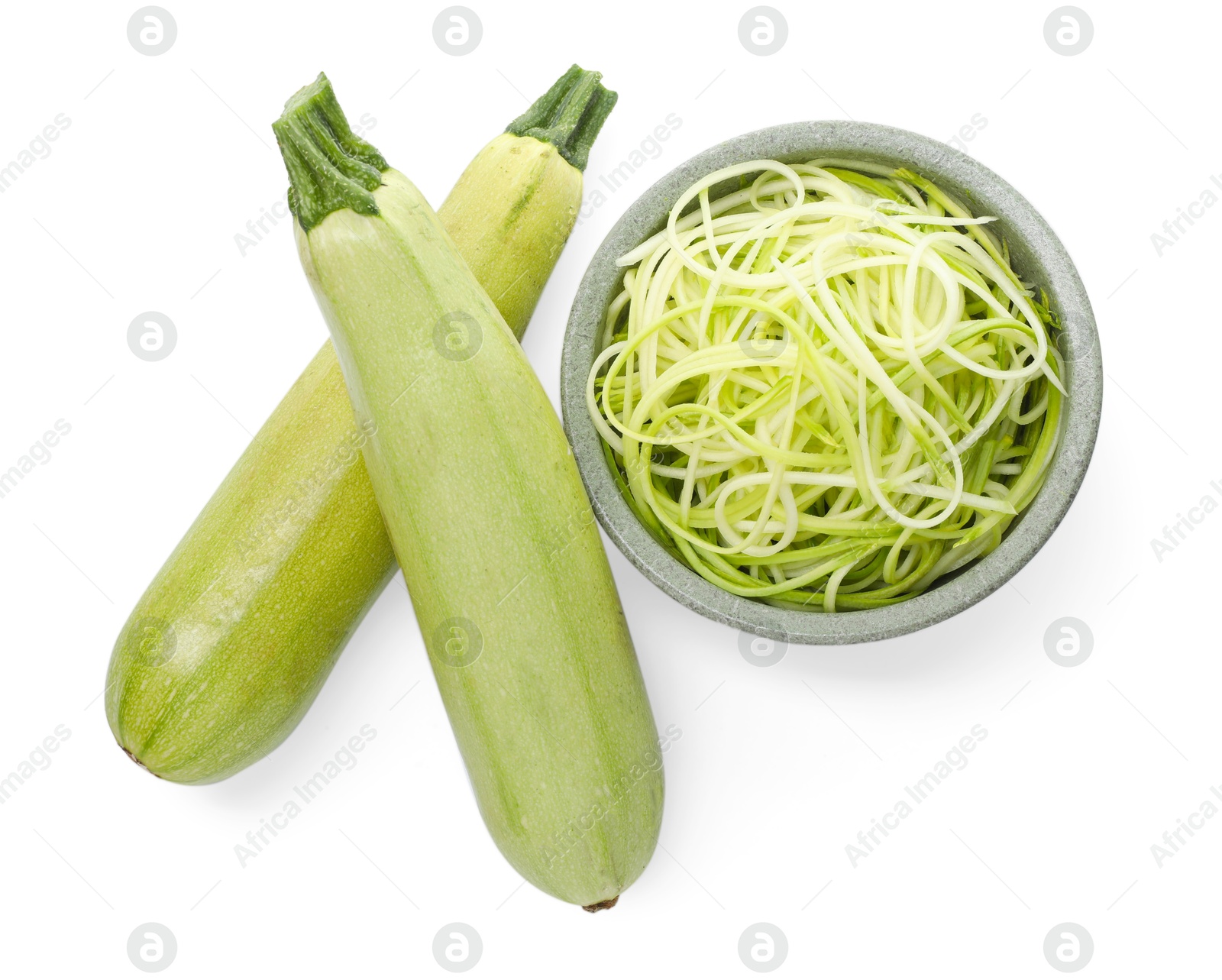 Photo of Raw squash noodles and fresh vegetables isolated on white, top view. Vegetarian dish