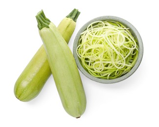 Photo of Raw squash noodles and fresh vegetables isolated on white, top view. Vegetarian dish
