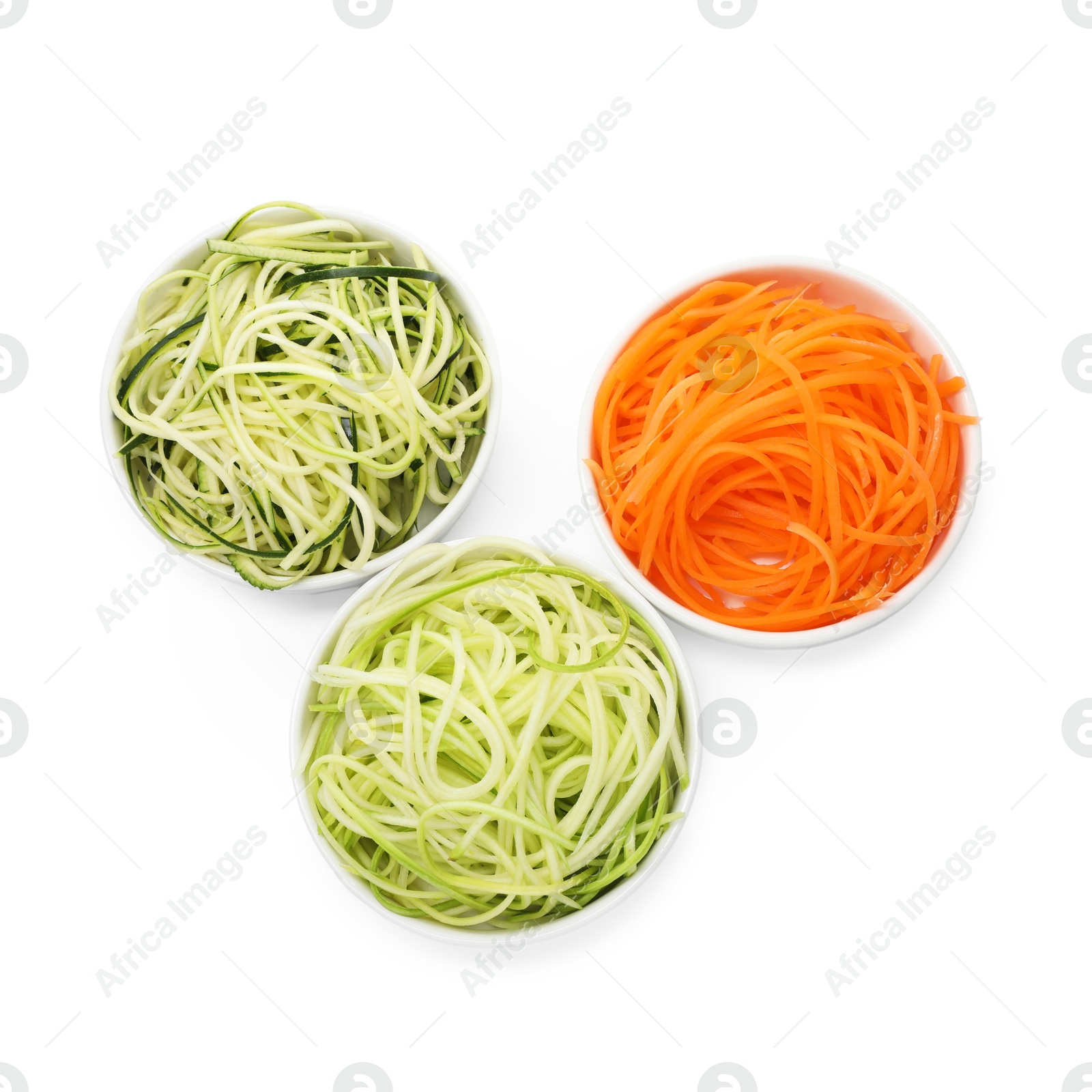Photo of Different vegetable noodles in bowls isolated on white, top view. Vegetarian dish