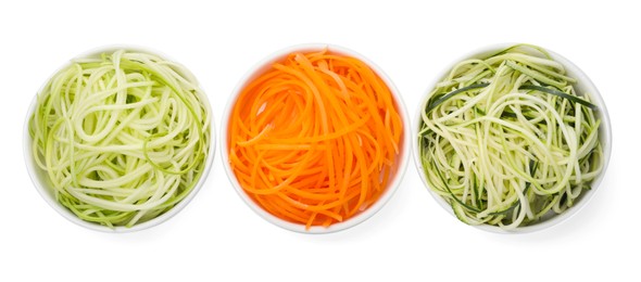 Photo of Different vegetable noodles in bowls isolated on white, top view. Vegetarian dish
