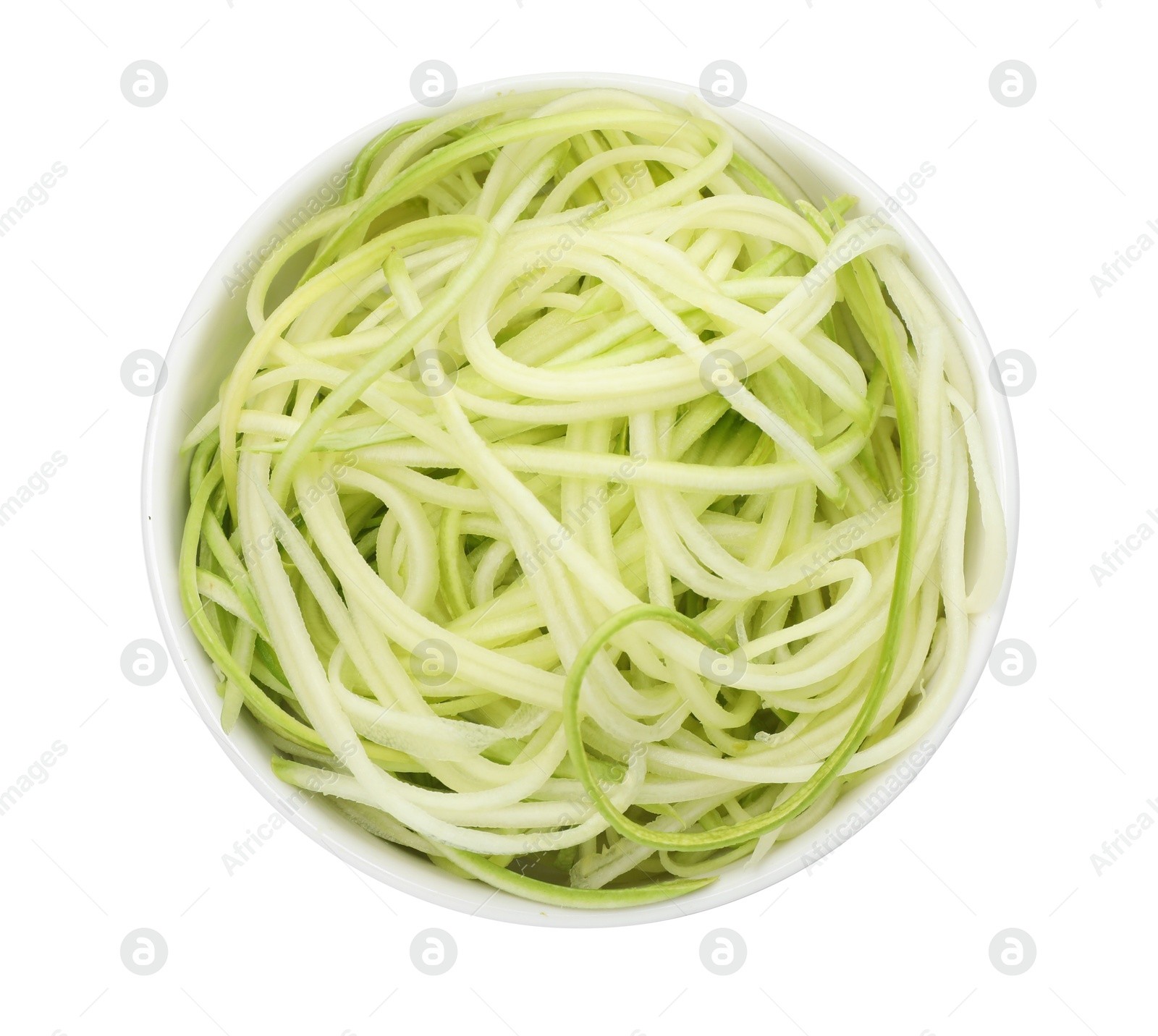 Photo of Raw squash noodles in bowl isolated on white, top view. Vegetarian dish
