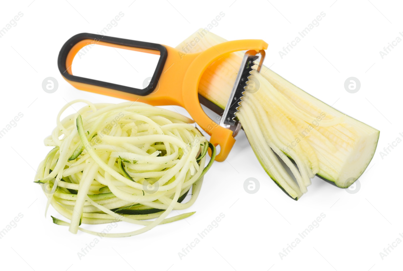 Photo of Raw zucchini noodles, peeler and fresh vegetable isolated on white. Vegetarian dish