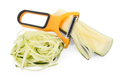 Photo of Raw zucchini noodles, peeler and fresh vegetable isolated on white. Vegetarian dish