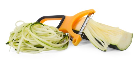 Photo of Raw zucchini noodles, peeler and fresh vegetable isolated on white. Vegetarian dish