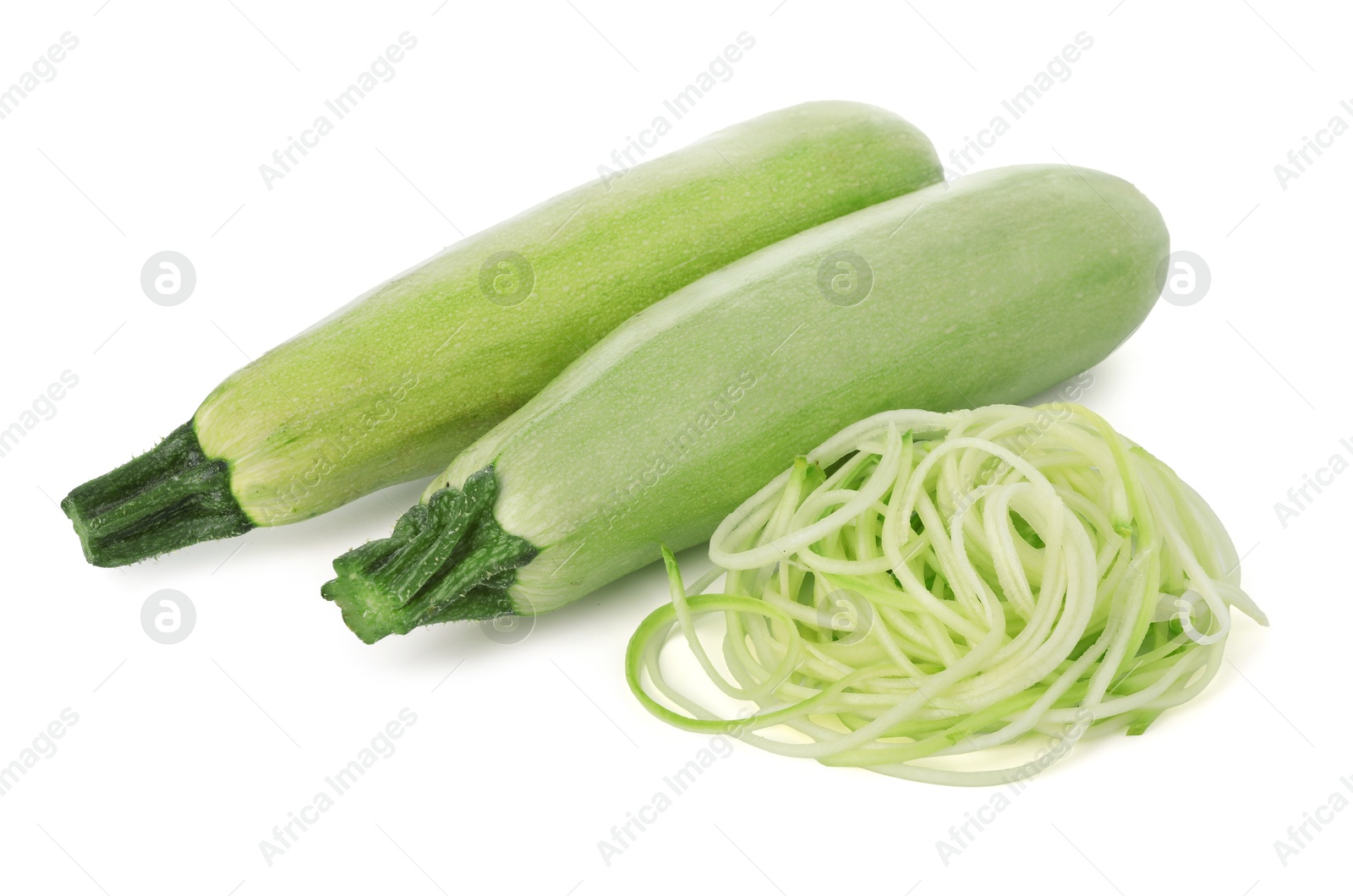 Photo of Raw squash noodles and fresh vegetables isolated on white. Vegetarian dish