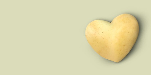 Image of Heart shaped potato on grey background, top view. Banner design with space for text