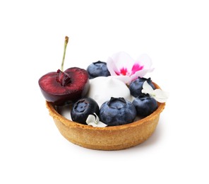 Photo of One sweet tartlet with berries and flowers isolated on white. Delicious dessert