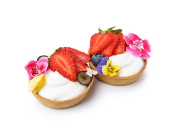 Photo of Sweet tartlets with berries and flowers isolated on white. Delicious dessert