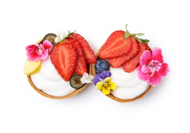 Photo of Sweet tartlets with berries and flowers isolated on white, top view. Delicious dessert