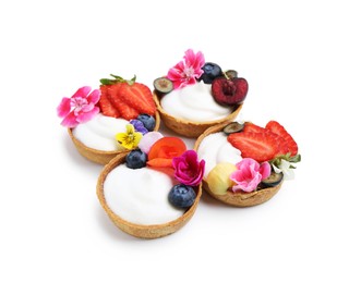 Photo of Sweet tartlets with berries and flowers isolated on white. Delicious dessert