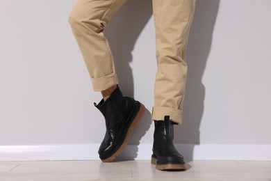 Photo of Man wearing pair of boots indoors, closeup